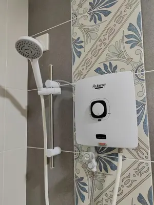 a bathroom with a shower with a hair dryer at Ipoh Anderson Suites in Ipoh