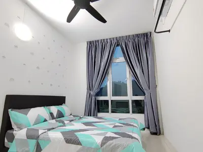 a bedroom with a bed and a window at Ipoh Anderson Suites in Ipoh