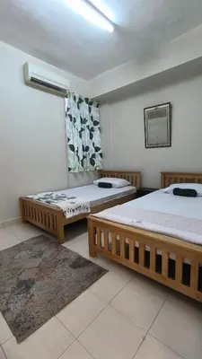 a room with two beds and a window in it at ANHAAZ Lakefront Retreat in Kampong Balek Bukit