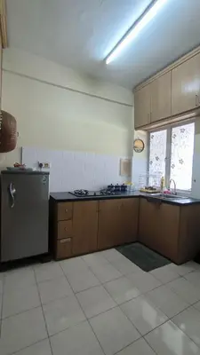 a kitchen with a stove and a refrigerator in it at ANHAAZ Lakefront Retreat in Kampong Balek Bukit