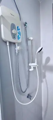 a shower in a bathroom with a hand held shower at Rainy Sanctuary Homestay With Netflix - 1 Parking in Taiping