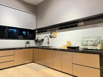 a kitchen with a sink and a counter top at Relax Guest House Taman Merak Jaya Simpang Ampat in Simpang Ampat