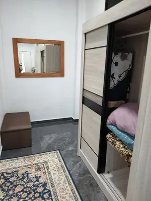 a bedroom with a dresser and a mirror at Makwan Homestay B in Kubang Semang