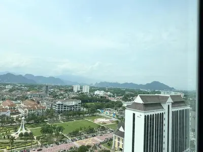 an aerial view of a city with a tall building at ICC Suites Ipoh 16th floor in Ipoh