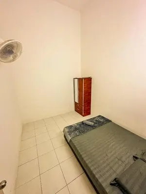 a small room with a bed and a fan at Sofea Homestay Raban Lake in Kampong Kuala Chegar
