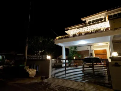 a house with a fence in front of it at night at D SeBalik Pulau Tropical Boutique Home in Balik Pulau