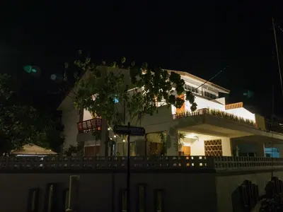 a white house with a tree in front of it at D SeBalik Pulau Tropical Boutique Home in Balik Pulau