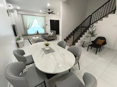 a living room with a white table and chairs at Spacious, 2 Storey Home, Up to 12 Pax, 4 Bedrooms, 4 Bathrooms, 2 Car Park Lots by Star Home in Sungai Petani