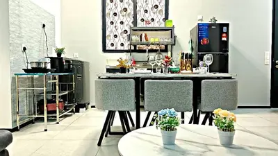 a room with a table with chairs and flowers in it at 3BR-Apartment-Netflix,Cozy,Peaceful FamilyHomes b30 in George Town