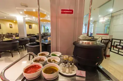 a buffet with bowls of food on a counter in a restaurant at Red Rock Hotel Penang in George Town