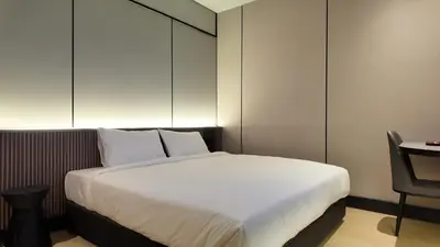a bed in a room with a desk and a bed sidx sidx sidx at Urban Inn, Cengal Jaya in Sungai Petani