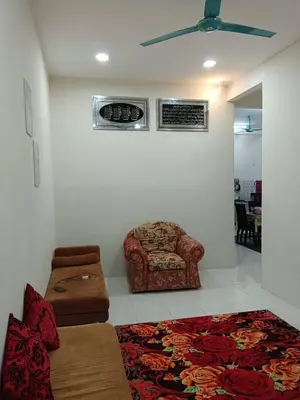 a living room with a couch and a chair at Homestay Ismail LEKIR in Sitiawan