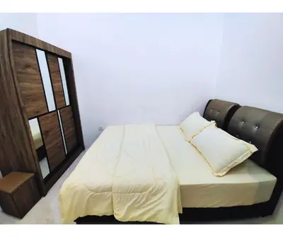 a bed with two pillows on it in a room at The Silverlakes Homestay in Batu Gajah