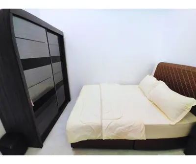 a bedroom with a tv and a white bed at The Silverlakes Homestay in Batu Gajah