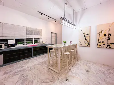 a kitchen with a table and stools in a room at Lakeside Pool Villa in LakeGarden & Zoo in Taiping
