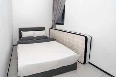 a bedroom with a bed and a white mattress at Creamy French at Urban Suite in George Town