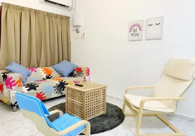 a living room with two chairs and a couch at Ria Serene Homestay in Sungai Petani