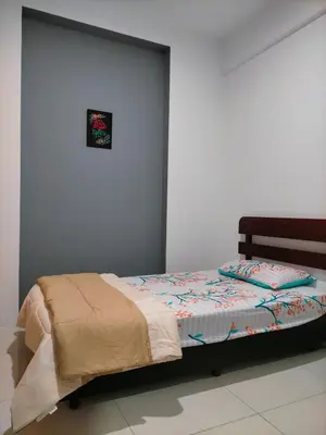 a bed in a room with a wall at Bern's Homestay Manhattan Condo, Ipoh-GROUND FLOOR, POOLSIDE, FREE PARKING and WiFi in Ipoh