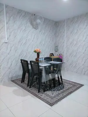 a dining room with a table and black chairs at Bern's Homestay Manhattan Condo, Ipoh-GROUND FLOOR, POOLSIDE, FREE PARKING and WiFi in Ipoh