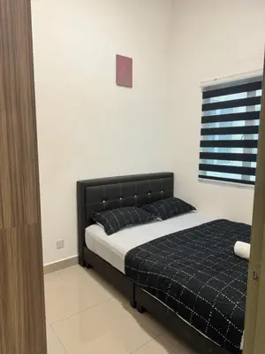a bedroom with a bed with a black headboard at AYAAN FIFA HOME at Quintet Private Parking in Tanah Rata