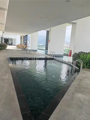 a swimming pool in the middle of a building at Urban Suite in George Town