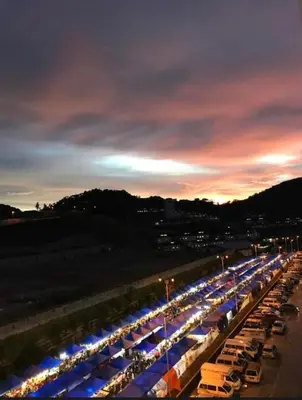 a long line of cars parked in a parking lot at night at Golden Hills 2 Bedroom Apartment in Brinchang