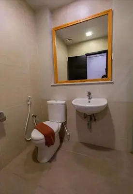 a bathroom with a toilet and a sink and a mirror at Nova Cameron Glamz in Cameron Highlands