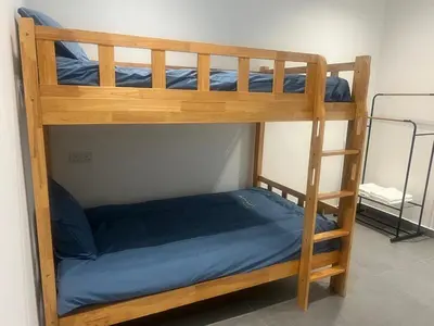 a bunk bed with a blue bed in a room at Canning Home in Ipoh