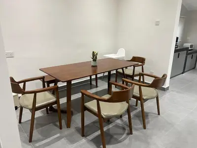 a wooden table and chairs in a room at Canning Home in Ipoh