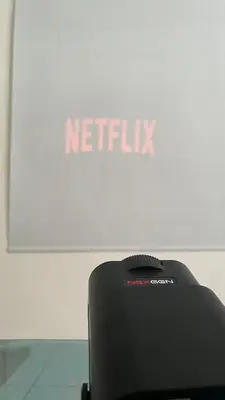 a netflix sign on top of a table in front of a screen at Memoir Perda in Bukit Mertajam