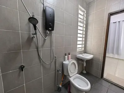 a bathroom with a toilet and a shower in it at Padang Serai Taman Ria 61 in Padang Serai