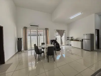 a dining room and kitchen with a table and chairs at Padang Serai Taman Ria 61 in Padang Serai