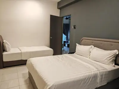 a hotel room with two beds and a mirror at W902WarmStay at EmeraldAvenueBrinchang in Brinchang