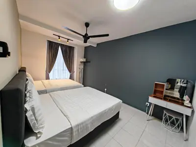 a bedroom with a bed and a table with a television at W902WarmStay at EmeraldAvenueBrinchang in Brinchang