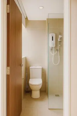 a bathroom with a toilet and a glass shower at 2 Connecting Room, Kozi Square in Gua Sai