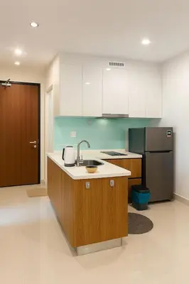 a kitchen with a sink and a refrigerator at 2 Connecting Room, Kozi Square in Gua Sai