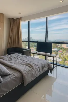 a bedroom with a bed and a desk with a computer at 2 Connecting Room, Kozi Square in Gua Sai