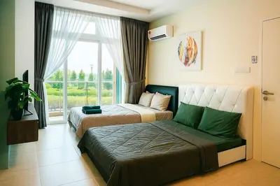 two beds in a room with a window at 2 Connecting Room, Riverine Diamond in Gua Sai