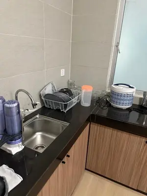 a kitchen with a sink and a counter top at Ayaan Snookers Home 3 at Quintet Apartment with Private Parking in Tanah Rata
