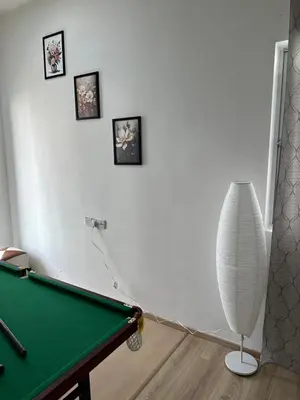 a room with a pool table and a white vase at Ayaan Snookers Home 3 at Quintet Apartment with Private Parking in Tanah Rata