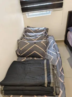 a pile of pillows sitting on top of a bed at Ayaan Gaming Home 2 Experience Real Life Simulator Racing Games in Tanah Rata