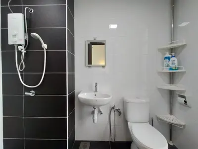 a bathroom with a shower and a toilet and a sink at Simple Bali l Projector l Netflix l 2 parking in Ipoh