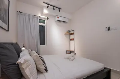 a white bedroom with a bed and a window at Simple Bali l Projector l Netflix l 2 parking in Ipoh