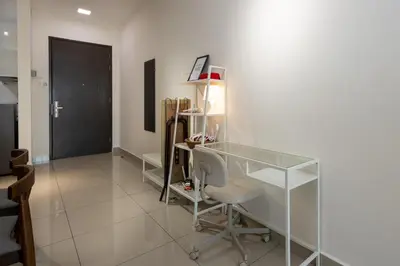 a room with a glass desk and a chair at Simple Bali l Projector l Netflix l 2 parking in Ipoh