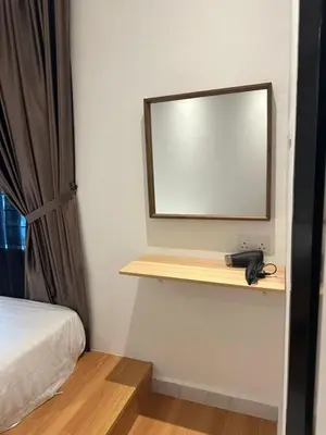 a mirror and a phone on a shelf in a room at Adik Aisyah black forest luxury cameron homestay in Tanah Rata