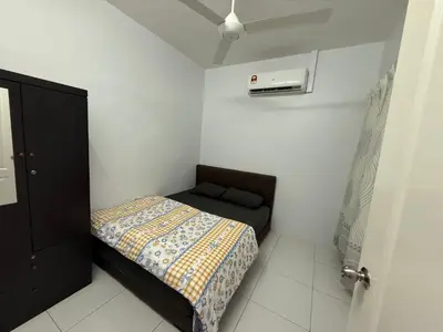 a small bedroom with a bed in a white room at DND Homestay Sitiawan in Sitiawan