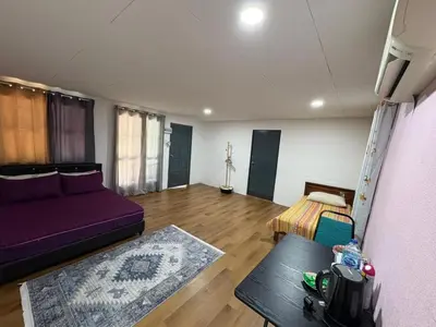 a living room with a purple couch and a table at Homestay Kenangan Kati Kuala Kangsar in Kuala Kangsar