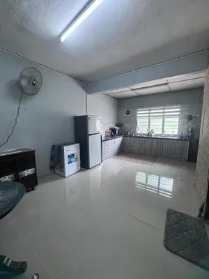 an empty room with a kitchen with a refrigerator at Homestay Pangkor Ann in Pangkor