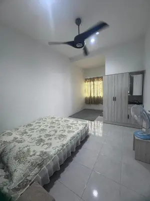 a bedroom with a bed and a ceiling fan at Homestay Manjung Ann in Seri Manjung