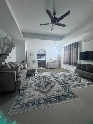 a living room with a couch and a ceiling fan at Homestay Manjung Ann in Seri Manjung